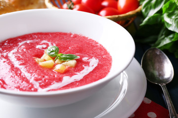 Gazpacho soup on color wooden background