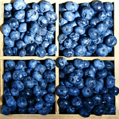 Tasty ripe blueberries in wooden crate, close up