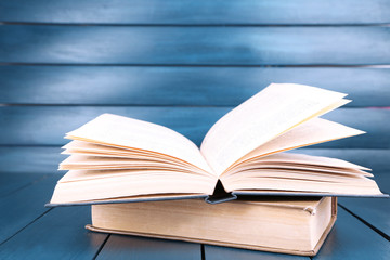 Books on dark blue wooden background