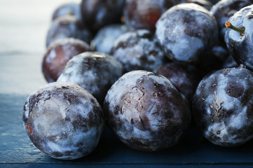 Ripe sweet plums on wooden table