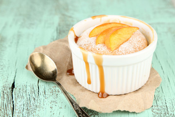 Tasty mini cake with fresh peach, on wooden table