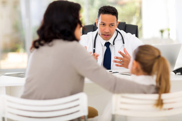 pediatrician consulting little patient in office