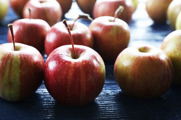 Juicy apples on wooden table, close-up