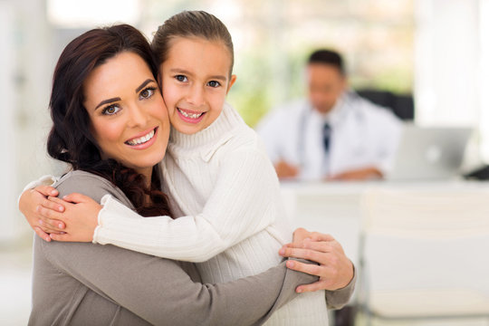 mother and daughter hugging in doctor's office