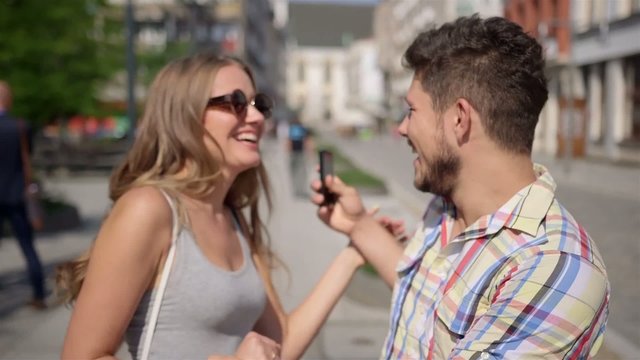 Cheerful young couple on a city street - meeting/date