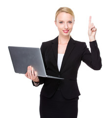 Caucasian businesswoman with notebook and finger up