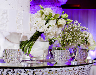 bouquet of white flowers in a glass vase in wedding ceremony