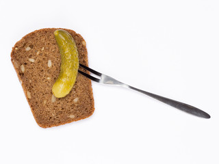 bread with grains and pickled cucumber