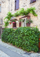 Fototapeta na wymiar Picturesque rustic street of a quaint hill town in France