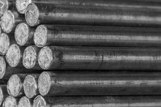 Stack of round steel bar - iron metal rail lines material.