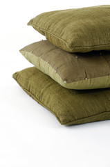 Three pillows stacked on white background