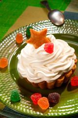 cake with cream and jelly on green plate