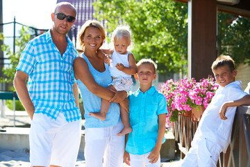 Happy family with three children standing together.