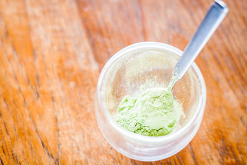 Spoon of green tea powder up close