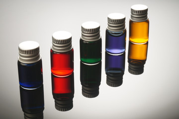 Colorful vials isolated on black background