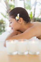 Obraz na płótnie Canvas Beautiful brunette relaxing on massage table