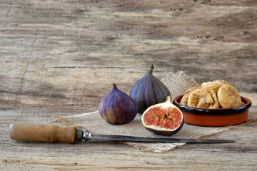 Fresh figs with knife and dried figs in bowl