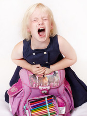 Cute child with school bag crying out loud