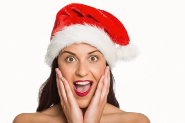 Surprised woman wearing santa hat