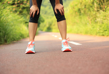 tired woman runner taking a rest after running  