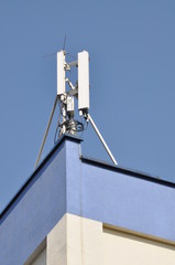 Cellular communication aerial on a building roof 