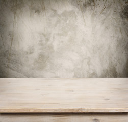 Wooden table on defocuced vintage wall background