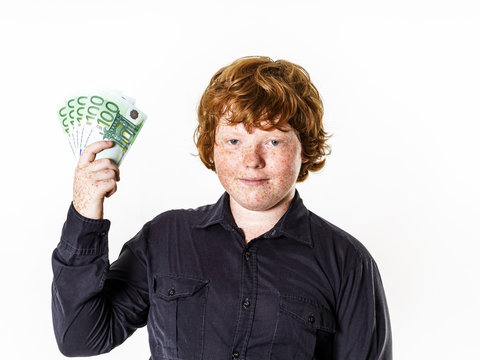 Happy red-haired boy with money