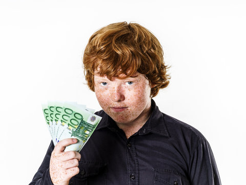 Happy red-haired boy with money