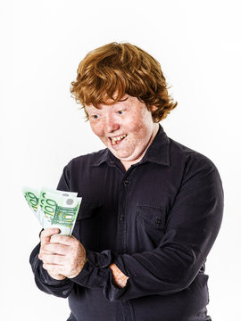 Happy red-haired boy with money