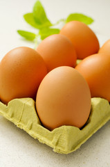 brown eggs in an egg carton