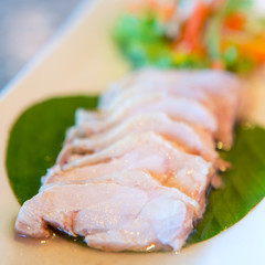 Sliced chicken breast fillet on a cutting board
