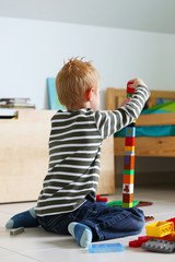 Boy playing with colored bricks