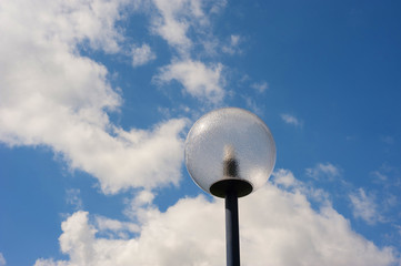 modern spherical lamppost in front of a cloudy sky