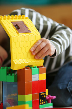 Boy playing with colored bricks
