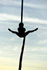 woman acrobatic dancer on aerial silk, aerial contortion
