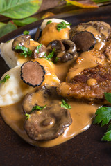 Steak with potato dumplings and forest mushroom sauce