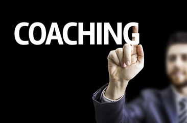 Business man pointing the text: Coaching