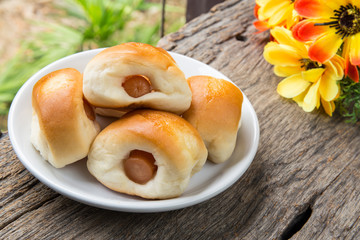 sausage in the bread on wood table
