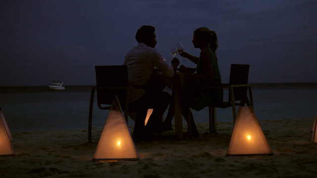 Couple Enjoying Late Meal In Outdoor Restaurant