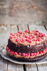 Chocolate cake with chocolate whipped cream and raspberries