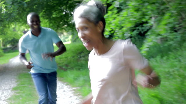 Mature African American Couple Running Along Country Path