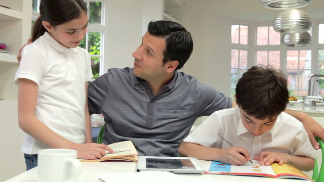 Father Helping Children With Homework