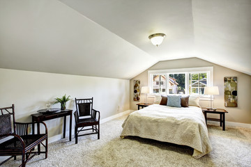Bedroom interior with vaulted ceiling and sitting area