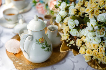 Obraz na płótnie Canvas Flowers, tea, marshmallows on a tray on the table
