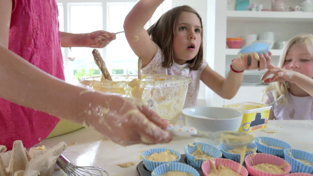 Three Little Girls Making Cake Together