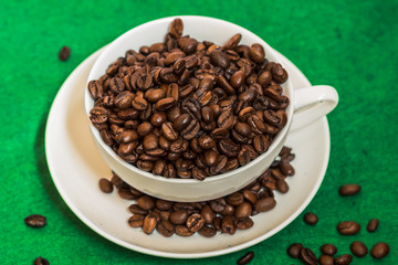 white cup with coffee beans
