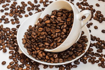 white cup with coffee beans