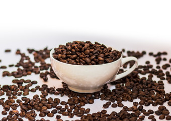 white cup with coffee beans