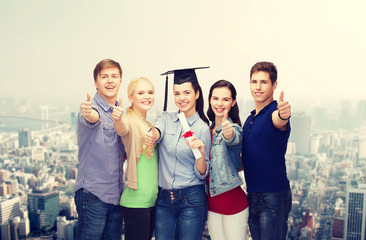 group of students with diploma showing thumbs up