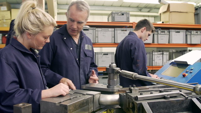 Engineer Teaching Apprentices To Use Tube Bending Machine